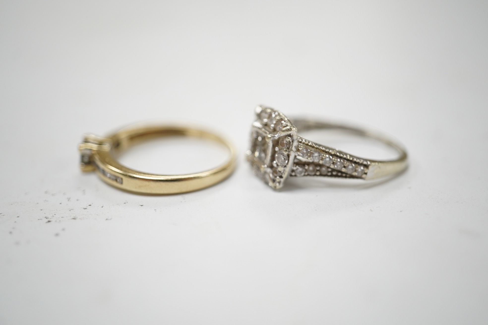 Two modern 9ct gold and diamond cluster set rings, sizes G and M/N, gross weight 4.9 grams. Condition - fair